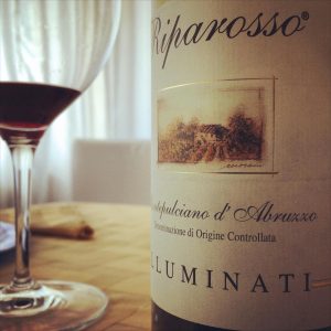 Elegant Montepulciano d'Abruzzo wine bottle with glass in Pescara, Italy.