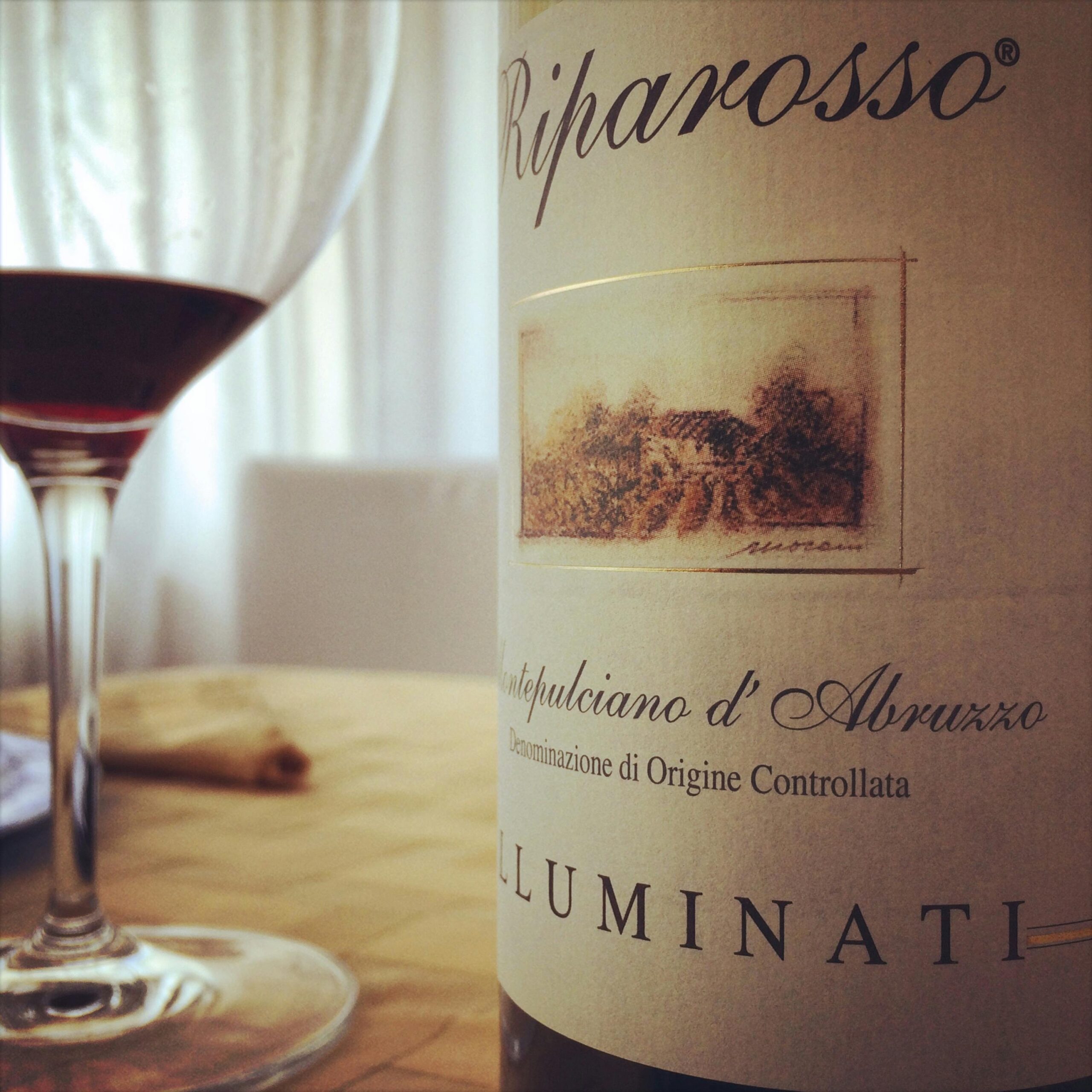 Elegant Montepulciano d'Abruzzo wine bottle with glass in Pescara, Italy.